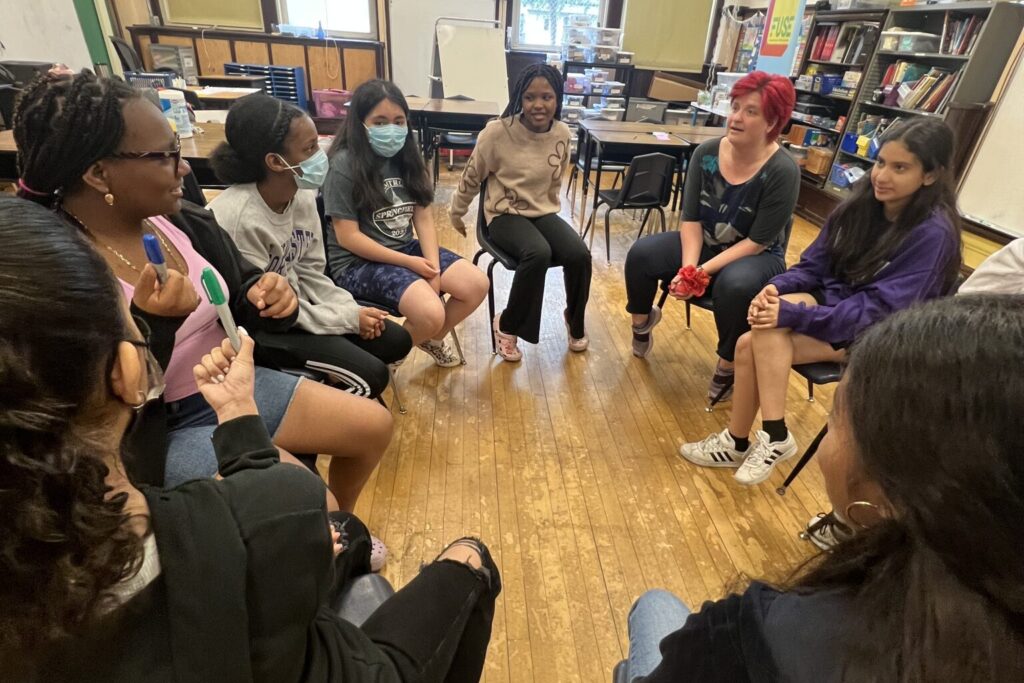 students seated in a circle for a group discussion