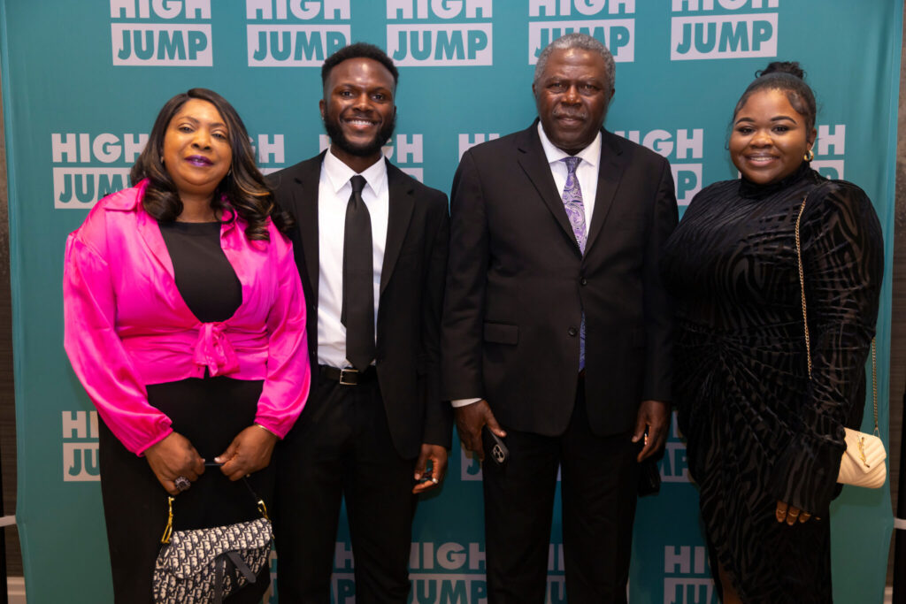 Richard stands with his parents and sister