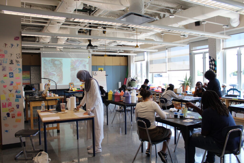 Students in a classroom working independently on creative art projects