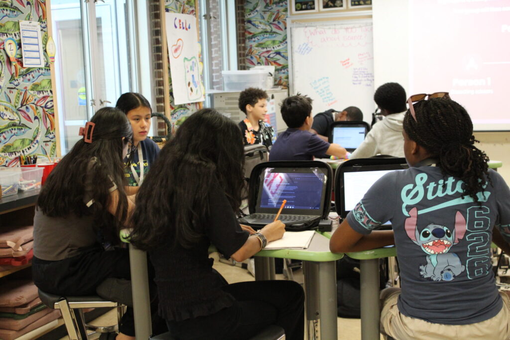 Students in a classroom working in small groups.